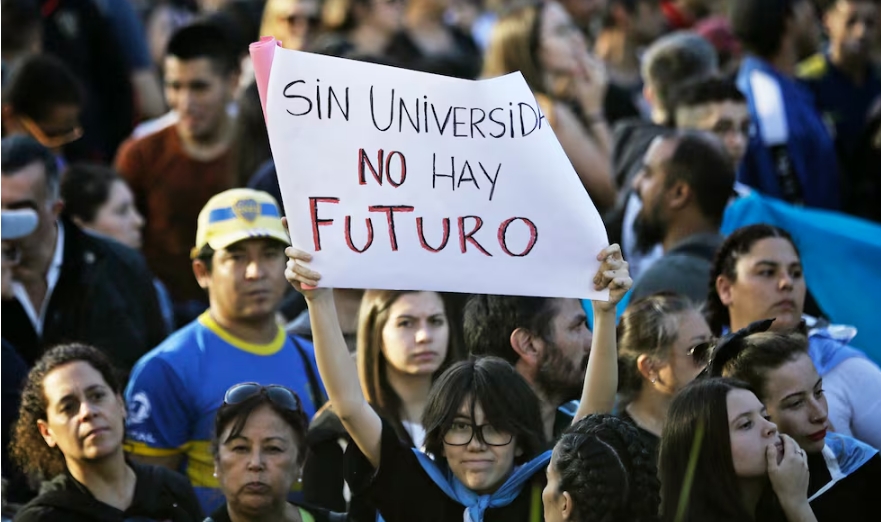 Marcha universitaria A demonstrator holds a sign that reads "Without university there is no future" during a march in protest of the budget adjustment to public universities in Buenos Aires on April 23, 2024. Tens of thousands of Argentine university students took to the streets Tuesday to protest cuts to higher public education, research and science under budget-slashing new President Javier Milei. (Photo by Emiliano Lasalvia / AFP) EMILIANO LASALVIA. AFP